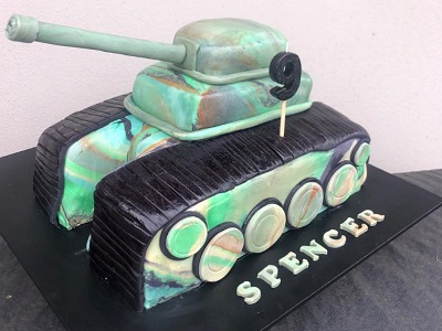 Army tank inspired cake. Vanilla sponge cake, layered with white chocolate ganache and covered in fondant. 100% edible excluding the turret (which has a straw in it)<br>Posted: October 14th, 2021.