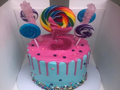 Chocolate mudcake, covered in buttercream, finished with pink drip, sprinkles and lollipops.<br>Posted: April 17th, 2022.